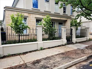 Black metal fence and gates along a residential frontage