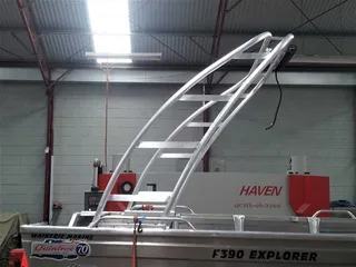 Curved metal canopy frame fitted to a boat in the workshop