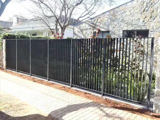 Black metal driveway fence and sliding gate