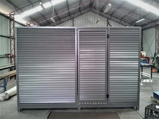 Double louvred metal cabinet doors in the workshop