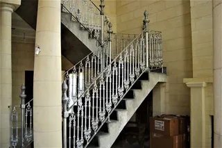 Ornate metal balustrade on a curved interior staircase