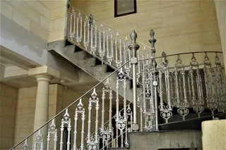Decorative metal balustrade around an interior staircase landing