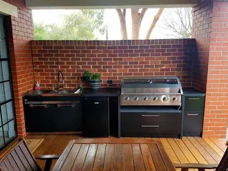 Completed outdoor kitchen with built-in barbecue and sink