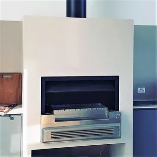 Stainless steel barbecue insert installed in an outdoor fireplace