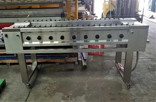 Large stainless steel barbecue with multiple controls on castors