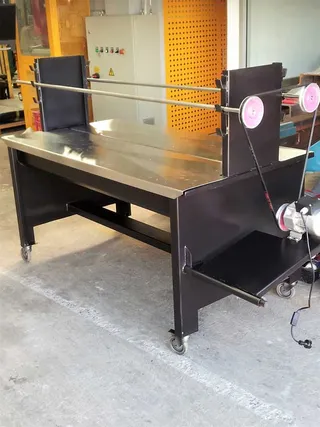 Black steel rotisserie barbecue frame with motor and spit