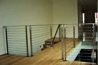 Stainless steel cable balustrade around a timber-floored landing