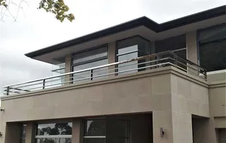 Stainless steel balcony balustrade wrapping an upper terrace