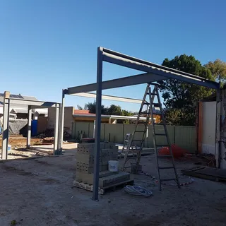 Painted steel portal frames installed at a residential building site