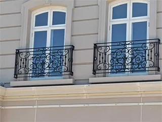 Pair of decorative wrought iron window balustrades