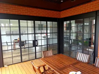 Black framed glass doors enclosing a covered patio