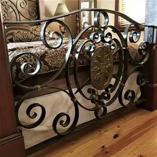 Decorative wrought iron interior barrier with a central medallion